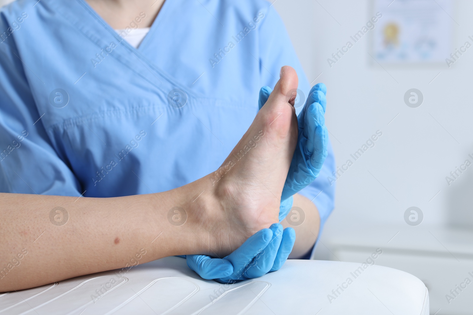 Photo of Doctor examining patient's foot in hospital, closeup