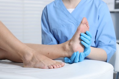 Photo of Doctor examining patient's foot in hospital, closeup