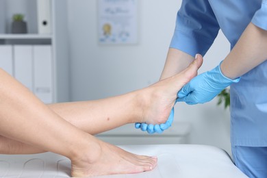 Photo of Doctor examining patient's foot in hospital, closeup