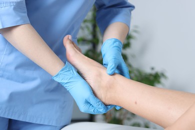 Photo of Doctor examining patient's foot in hospital, closeup