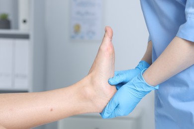 Photo of Doctor examining patient's foot in hospital, closeup