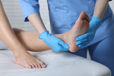 Photo of Doctor examining patient's foot in hospital, closeup