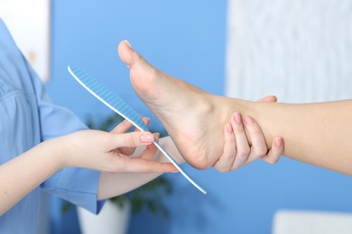 Photo of Doctor fitting insole to patient's foot in hospital, closeup