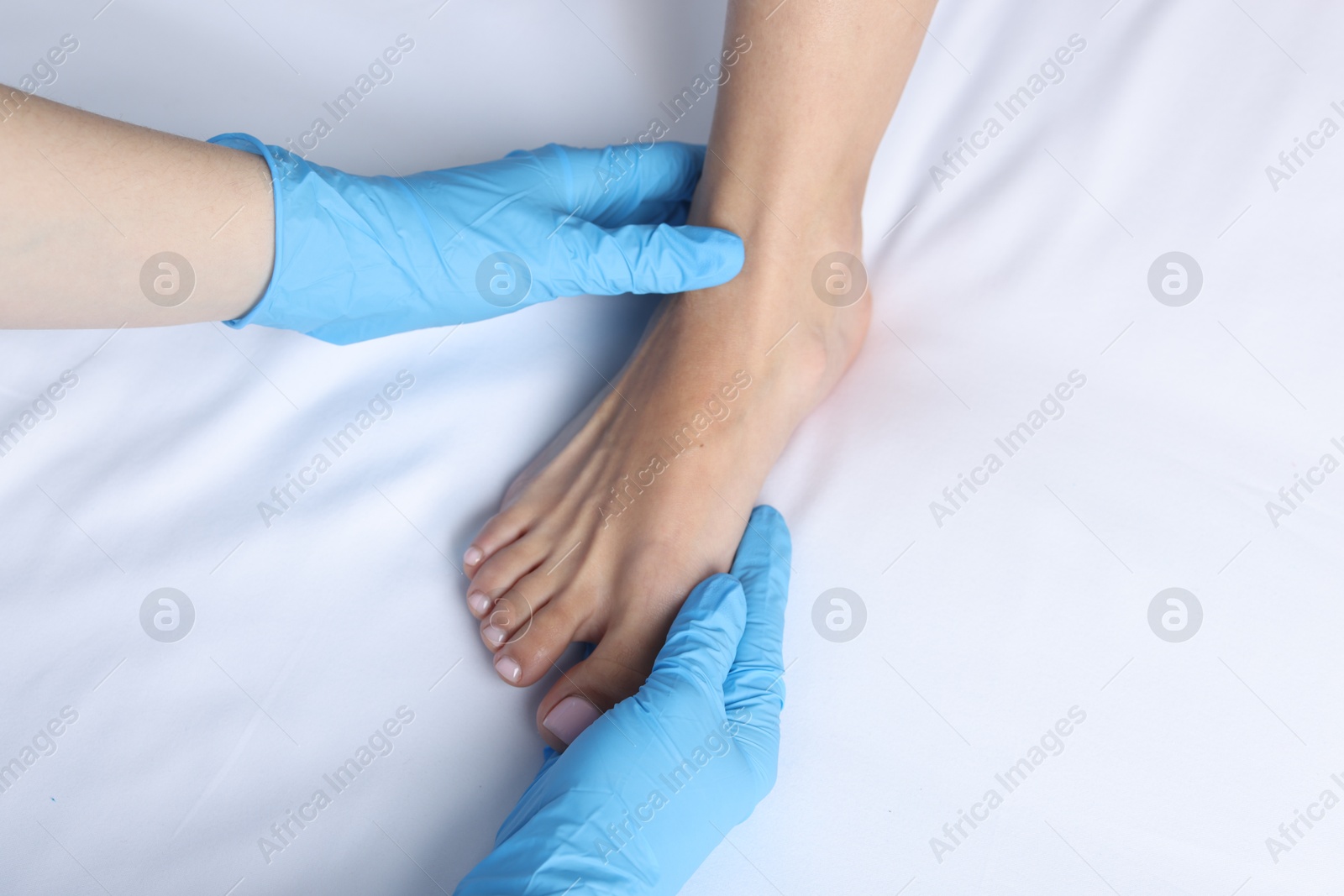 Photo of Doctor examining patient's foot in hospital, top view