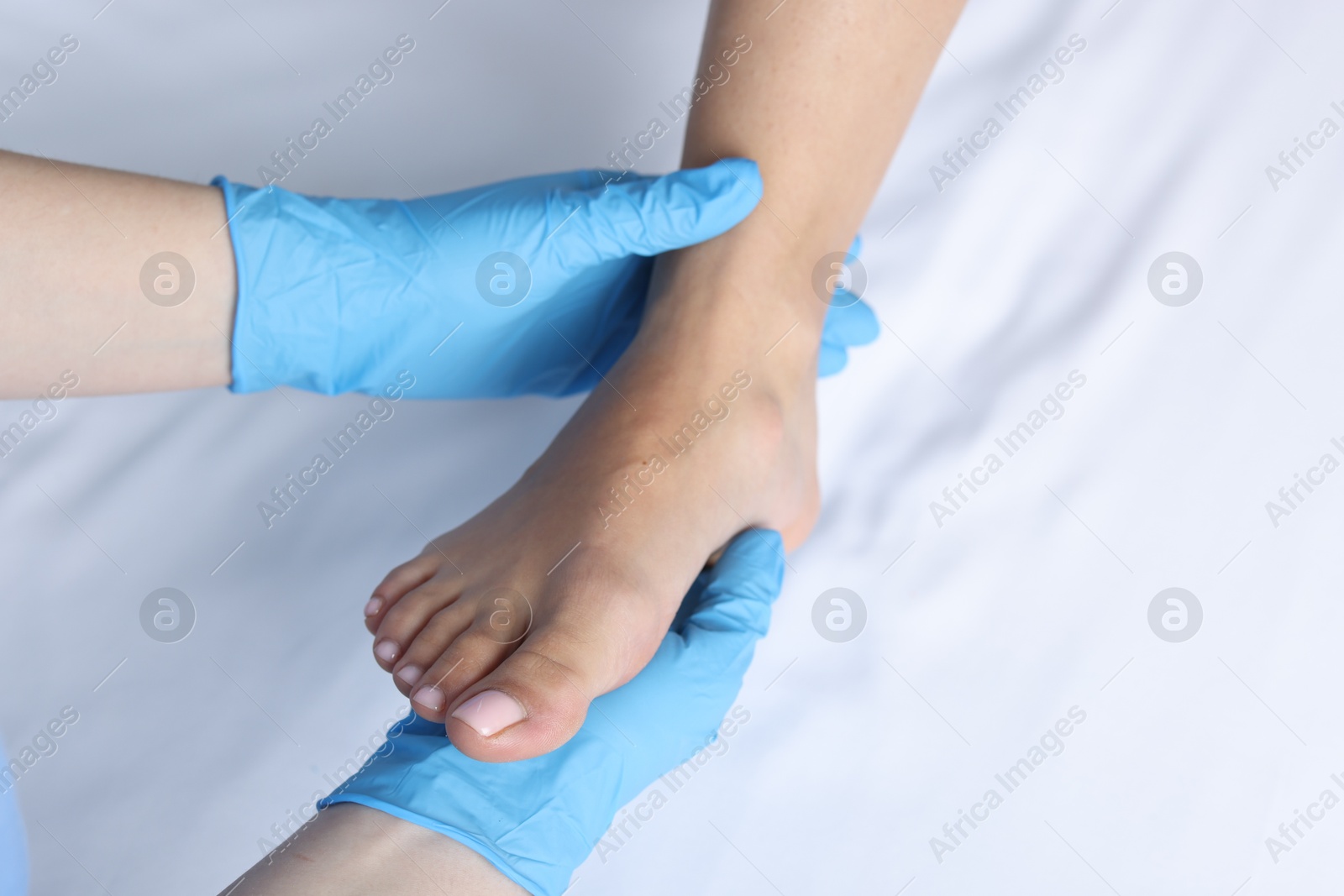 Photo of Doctor examining patient's foot in hospital, top view