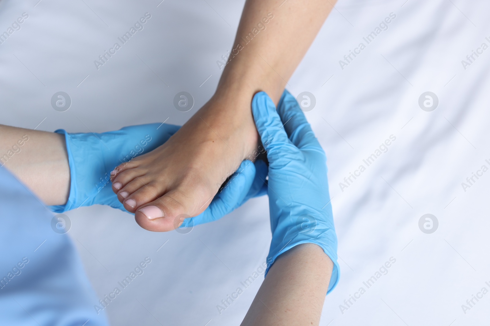 Photo of Doctor examining patient's foot in hospital, top view