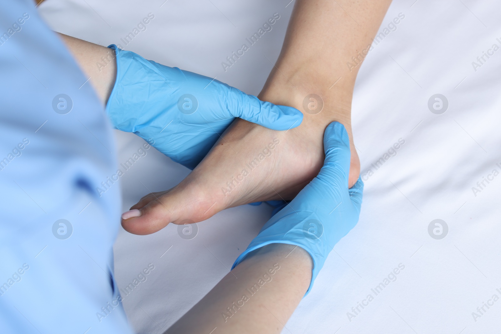 Photo of Doctor examining patient's foot in hospital, top view