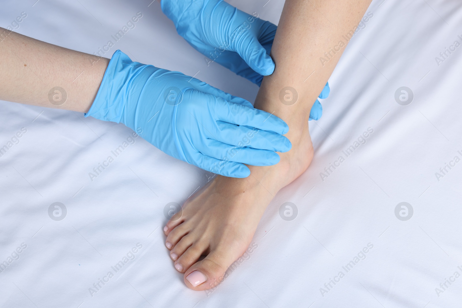 Photo of Doctor examining patient's foot in hospital, top view