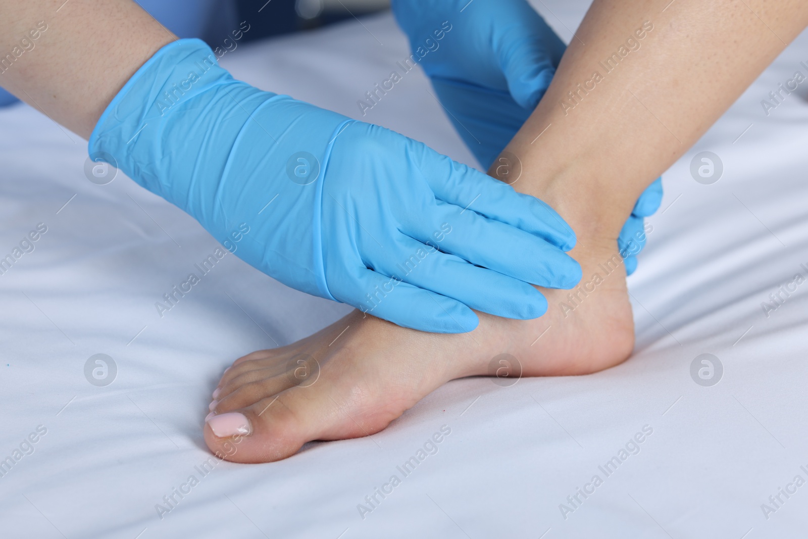 Photo of Doctor examining patient's foot in hospital, closeup