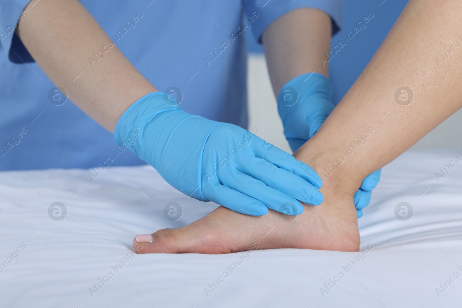 Photo of Doctor examining patient's foot in hospital, closeup