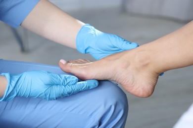 Photo of Doctor examining patient's foot in hospital, closeup