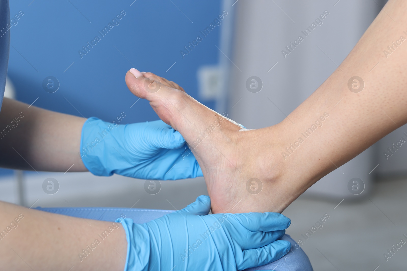 Photo of Doctor examining patient's foot in hospital, closeup