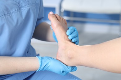 Photo of Doctor examining patient's foot in hospital, closeup