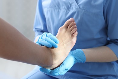 Photo of Doctor examining patient's foot in hospital, closeup