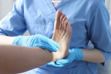 Photo of Doctor examining patient's foot in hospital, closeup