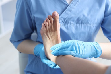 Photo of Doctor examining patient's foot in hospital, closeup