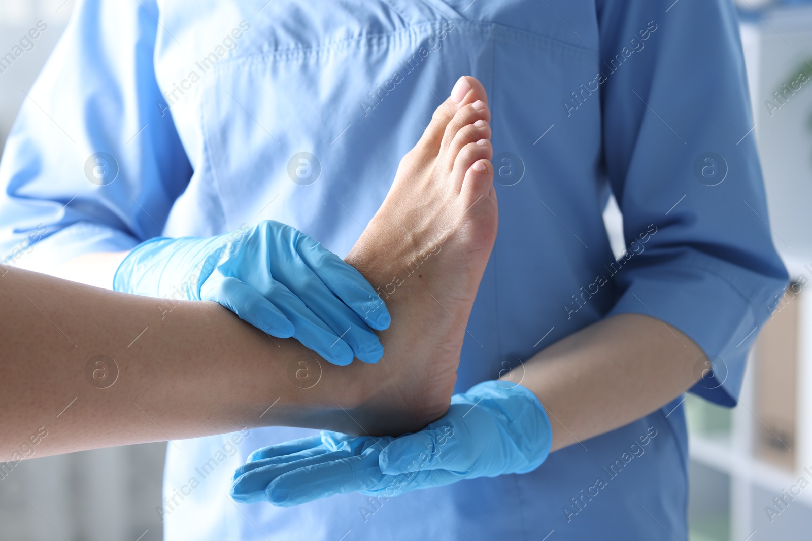 Photo of Doctor examining patient's foot in hospital, closeup