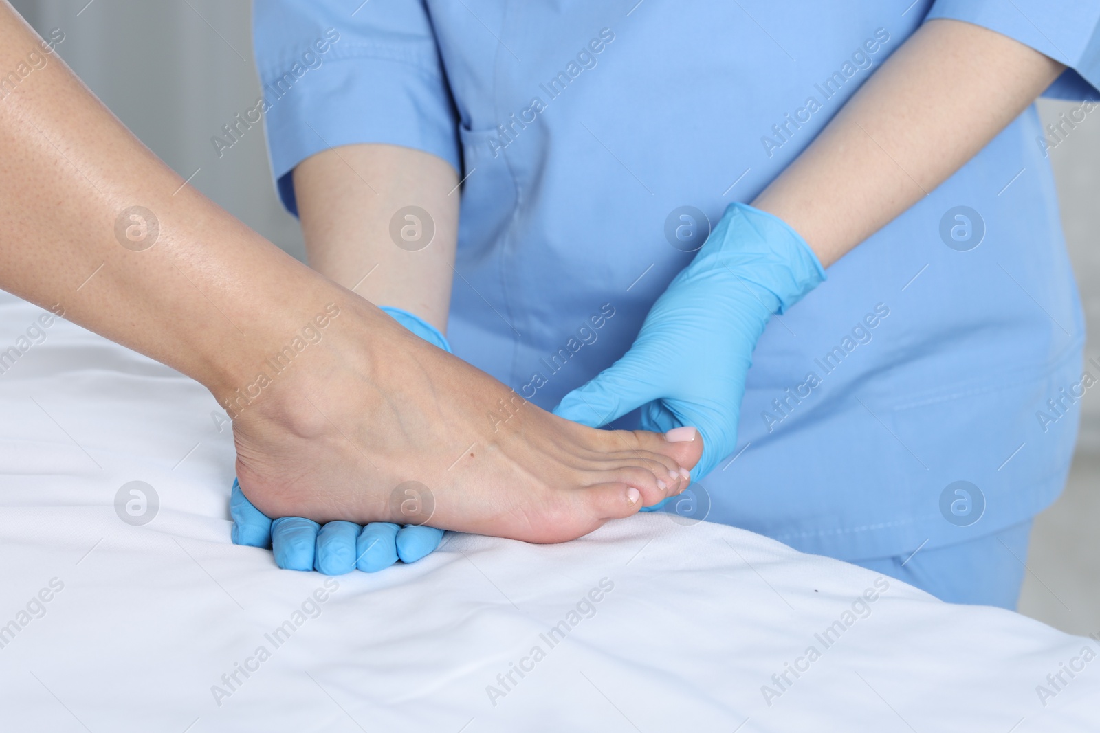 Photo of Doctor examining patient's foot in hospital, closeup