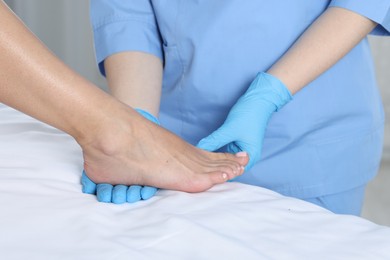 Photo of Doctor examining patient's foot in hospital, closeup