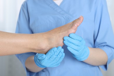 Photo of Doctor examining patient's foot in hospital, closeup