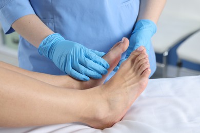 Photo of Doctor examining patient's foot in hospital, closeup