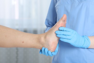 Photo of Doctor examining patient's foot in hospital, closeup