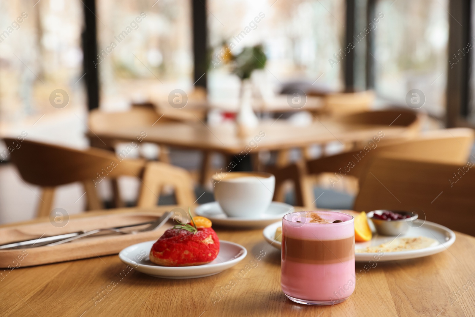 Photo of Delicious cottage cheese pancakes, dessert and coffee served on wooden table in cafe