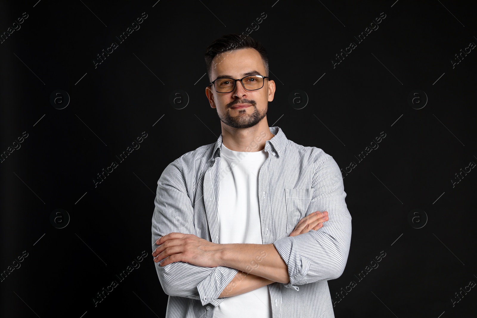 Photo of Portrait of handsome middle aged man on black background