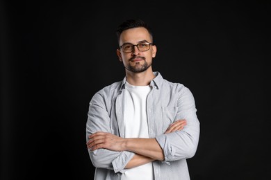 Photo of Portrait of handsome middle aged man on black background