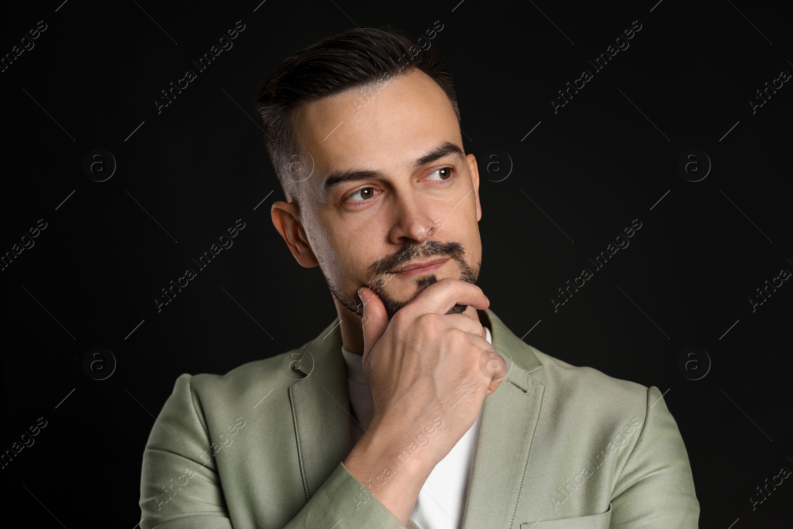 Photo of Portrait of handsome middle aged man on black background