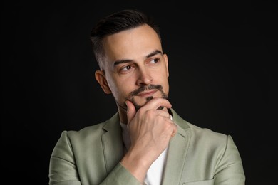 Photo of Portrait of handsome middle aged man on black background