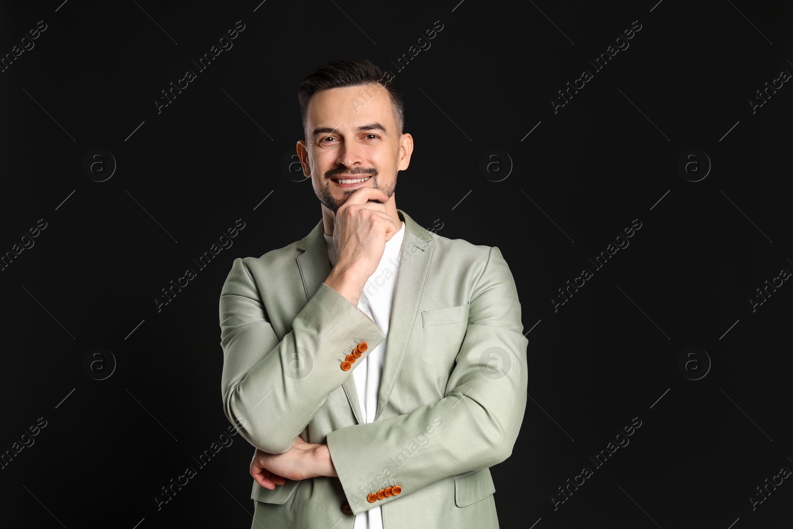 Photo of Portrait of handsome middle aged man on black background