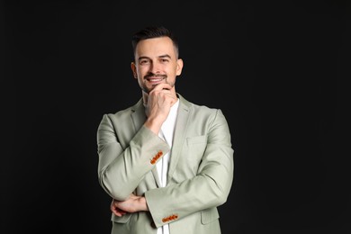 Photo of Portrait of handsome middle aged man on black background