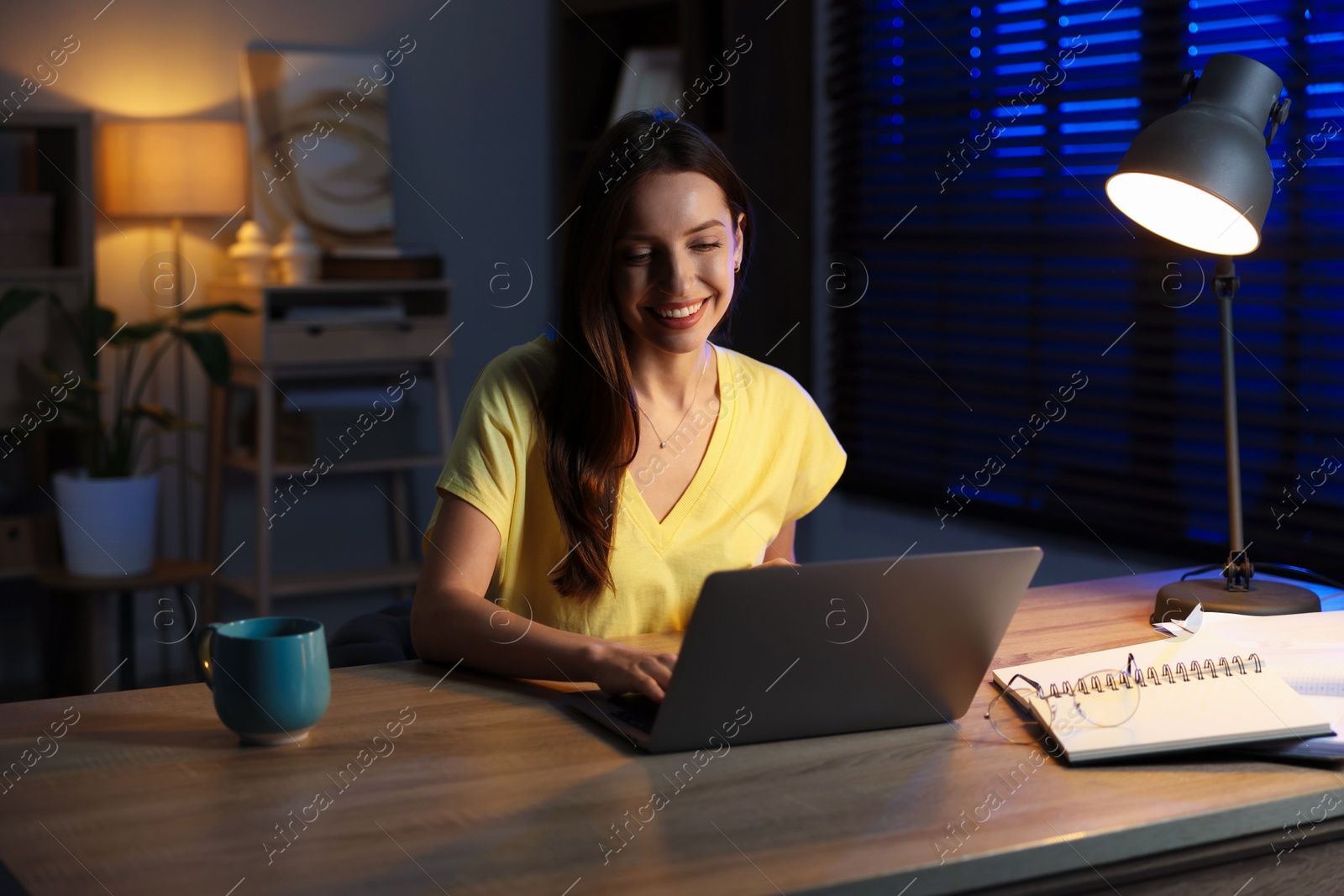 Photo of Woman working on laptop at desk in home office