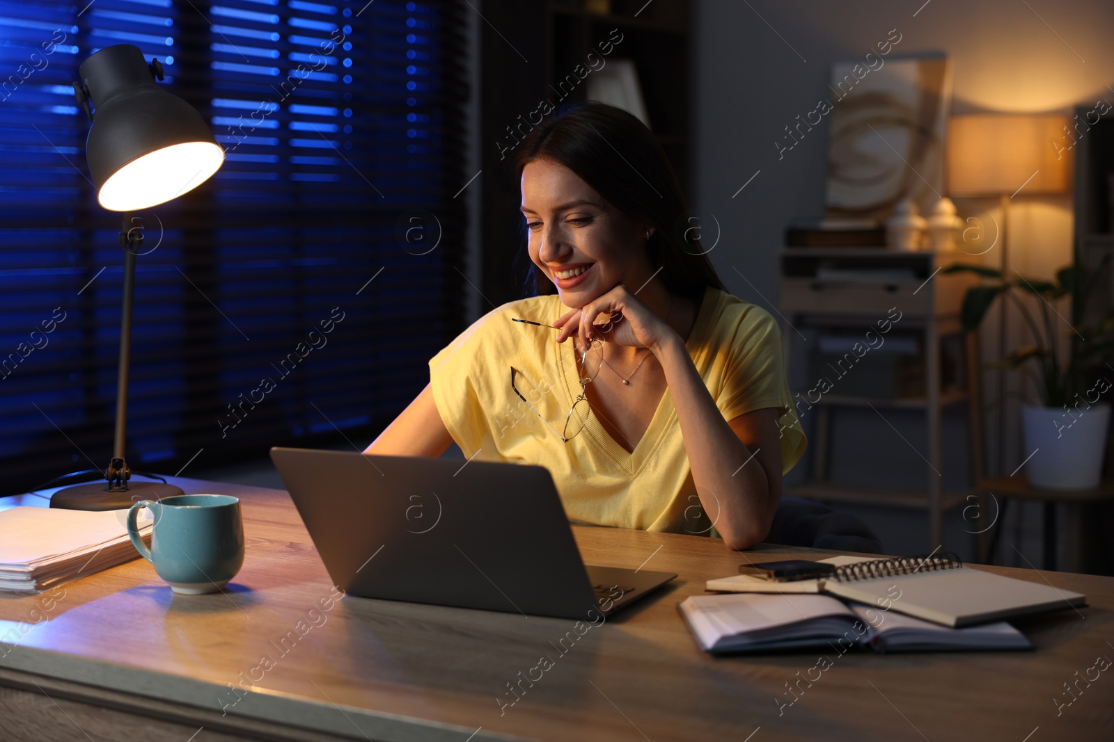 Photo of Woman working on laptop at desk in home office