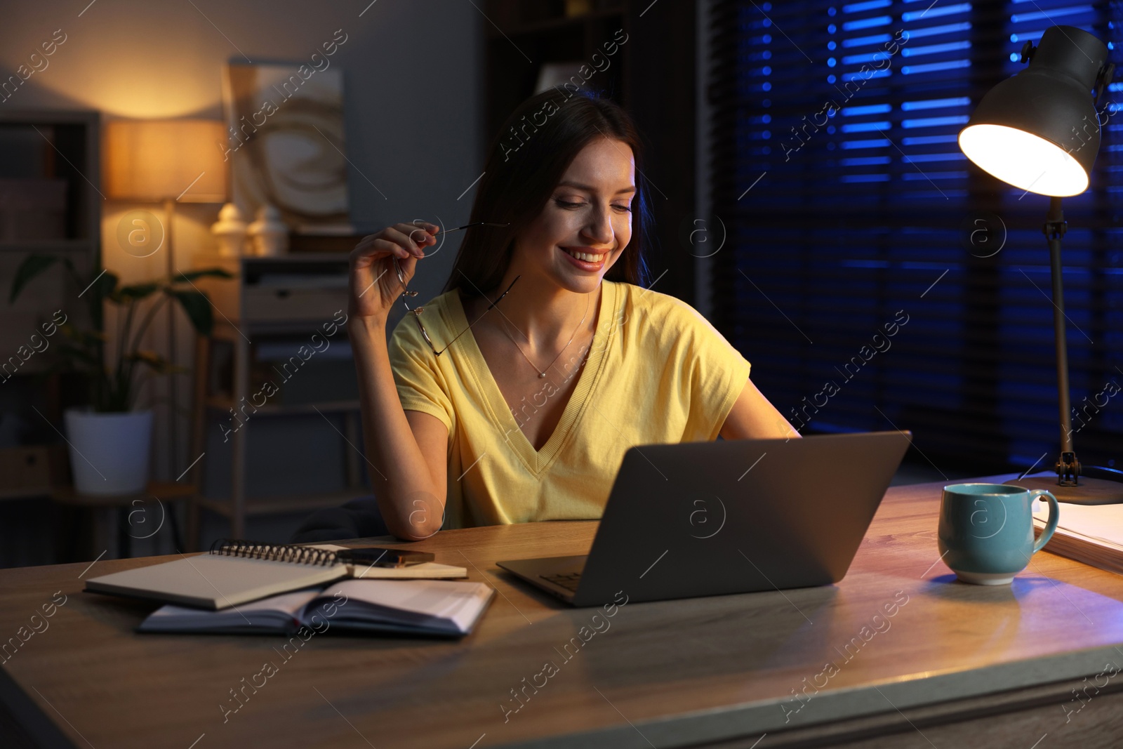 Photo of Woman working on laptop at desk in home office