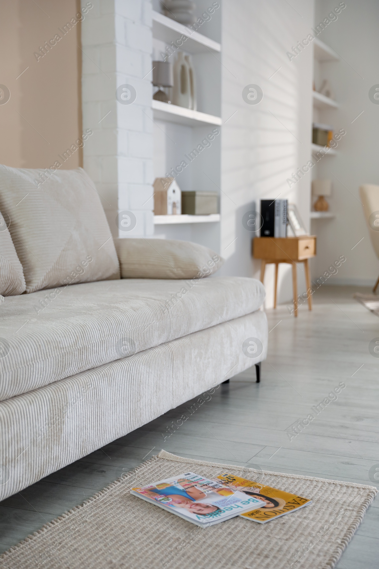 Photo of Comfortable sofa with pillows in living room