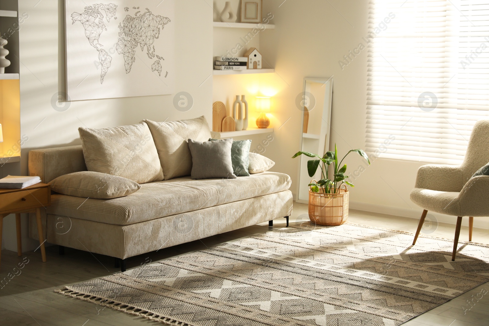 Photo of Comfortable sofa with pillows, armchair and houseplant in living room