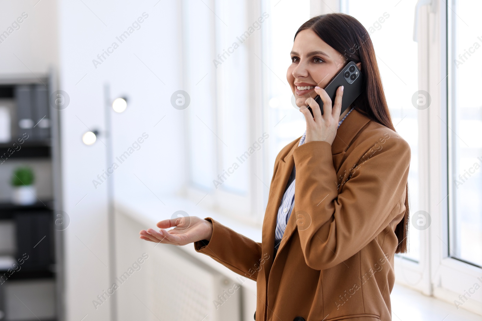 Photo of Banker talking on smartphone in office, space for text