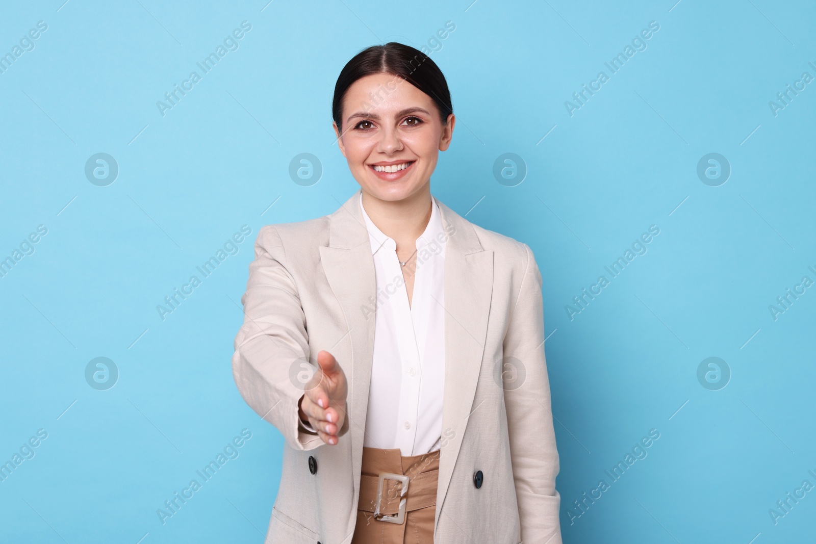 Photo of Portrait of banker in jacket on light blue background