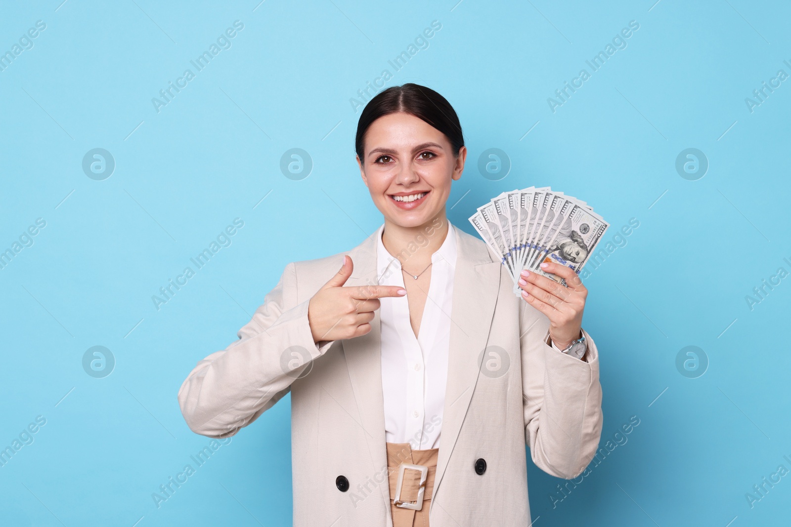 Photo of Banker with dollar banknotes on light blue background