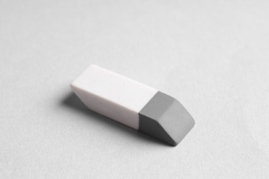 Photo of One eraser on grey background, closeup view