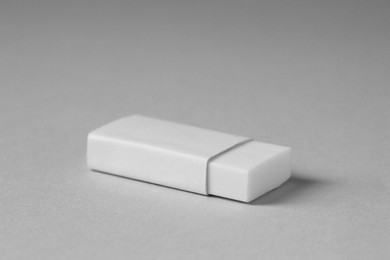 Photo of One eraser on grey background, closeup view