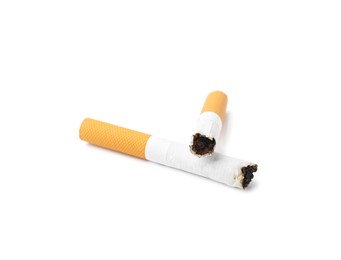 Photo of Two cigarette butts isolated on white. Smoking habit