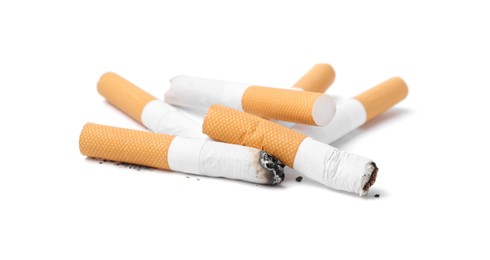 Photo of Many cigarette butts isolated on white. Smoking habit