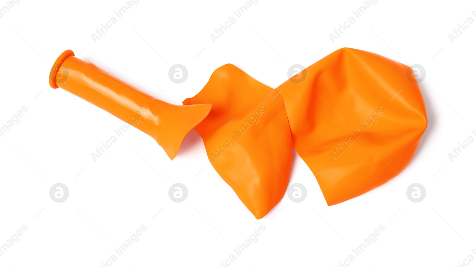 Photo of One orange popped balloon isolated on white, top view