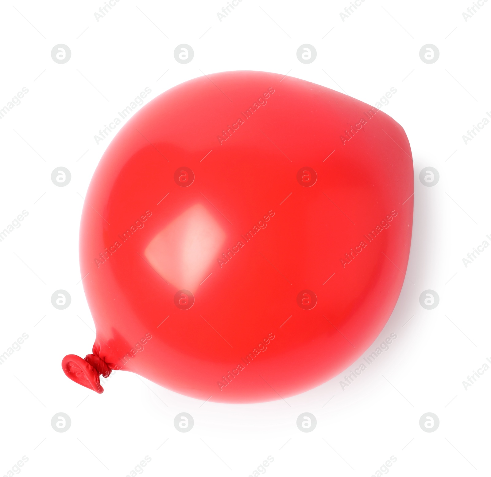 Photo of One red half deflated balloon isolated on white, top view