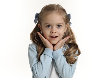 Photo of Cute little girl with beautiful hair accessory on white background