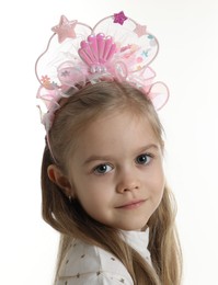 Photo of Cute little girl with beautiful headband on white background