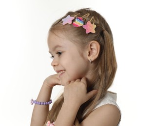 Photo of Cute little girl with beautiful hair clips on white background